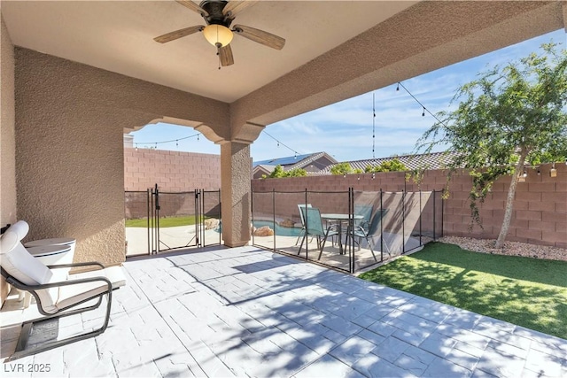 view of patio featuring a fenced backyard and a ceiling fan