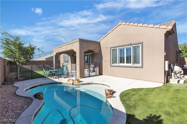 rear view of property with a patio area and stucco siding