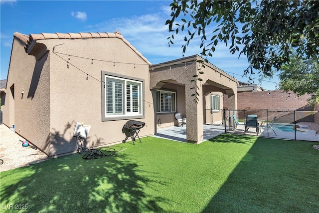 back of house with stucco siding and a patio area