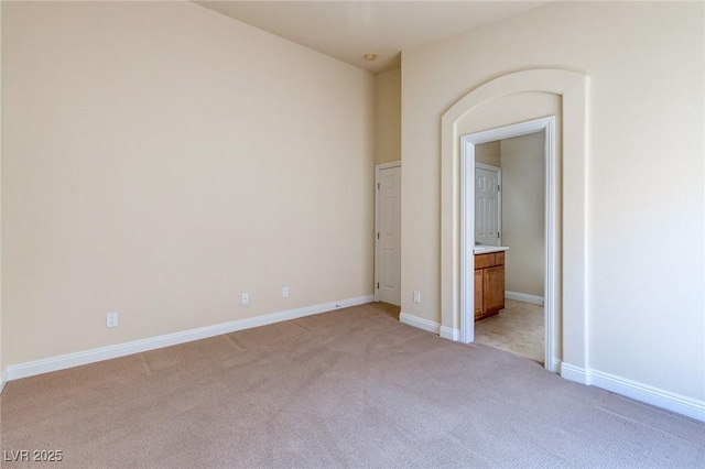 1963 Dakota Lodge Ave, Las Vegas, NV 89123 - unfurnished bedroom featuring light colored carpet, baseboards, and ensuite bathroom