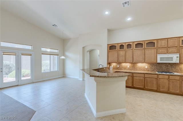 1963 Dakota Lodge Ave, Las Vegas, NV 89123 - kitchen featuring white appliances, light tile patterned flooring, a sink, stone counters, and high vaulted ceiling