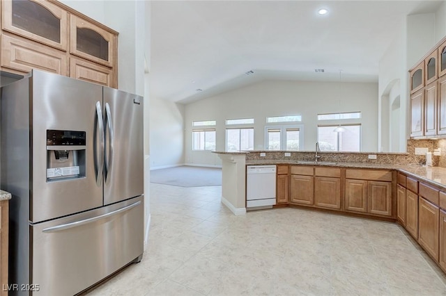 1963 Dakota Lodge Ave, Las Vegas, NV 89123 - kitchen featuring stainless steel refrigerator with ice dispenser, white dishwasher, vaulted ceiling, a sink, and a peninsula