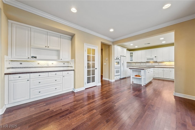 7438 Desertscape Ave, Las Vegas, NV 89178 - kitchen featuring white appliances, open shelves, dark countertops, baseboards, and backsplash