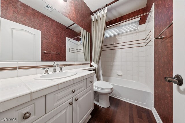 7438 Desertscape Ave, Las Vegas, NV 89178 - full bathroom featuring wood finished floors, toilet, vanity, and shower / tub combo with curtain