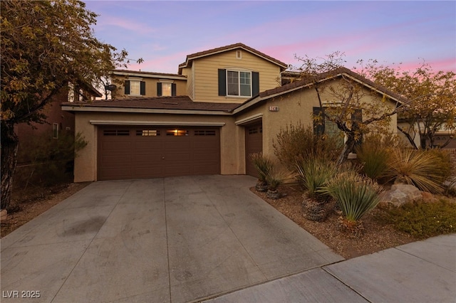 7438 Desertscape Ave, Las Vegas, NV 89178 - traditional home featuring stucco siding, concrete driveway, and an attached garage