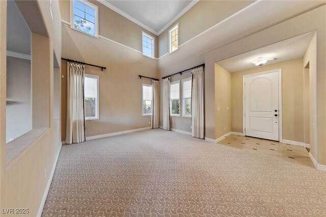 7438 Desertscape Ave, Las Vegas, NV 89178 - spare room featuring carpet flooring, plenty of natural light, baseboards, and crown molding