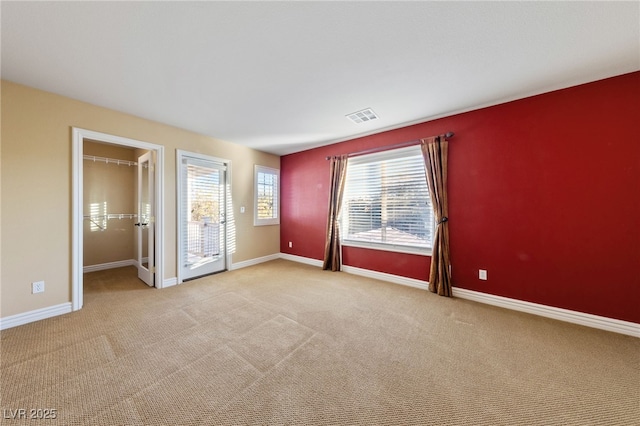 7438 Desertscape Ave, Las Vegas, NV 89178 - unfurnished bedroom with carpet flooring, a spacious closet, baseboards, and access to exterior