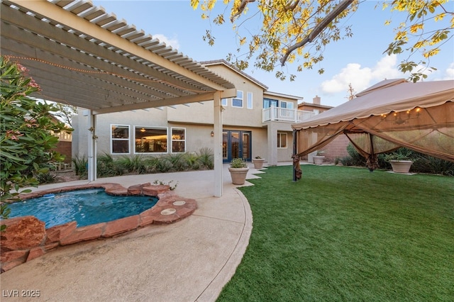 7438 Desertscape Ave, Las Vegas, NV 89178 - back of property featuring a pergola, stucco siding, a lawn, a patio area, and a gazebo