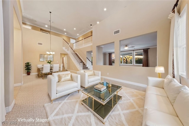 7438 Desertscape Ave, Las Vegas, NV 89178 - carpeted living area featuring a towering ceiling, recessed lighting, baseboards, a ceiling fan, and a chandelier