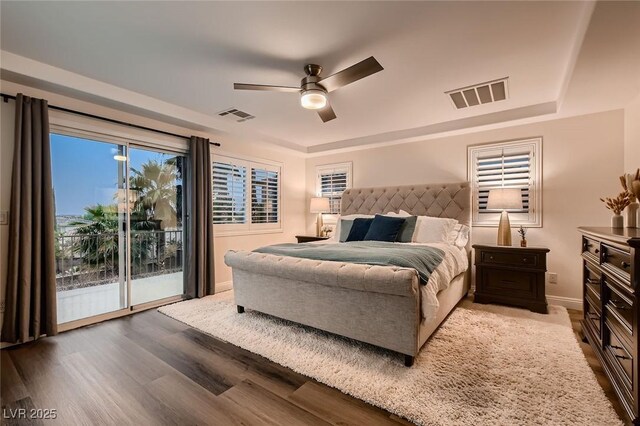 bedroom with access to exterior, wood finished floors, baseboards, and a ceiling fan