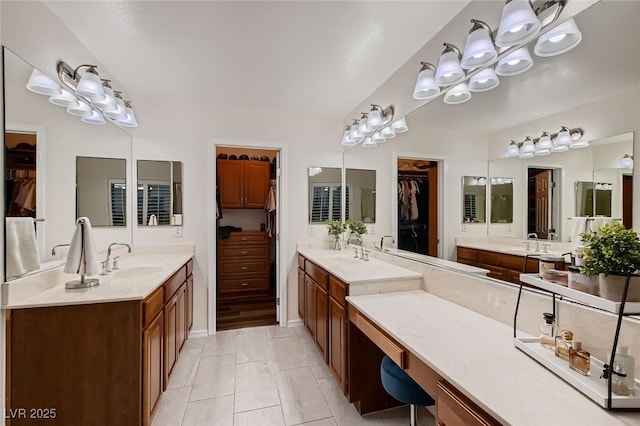 full bath featuring two vanities and a walk in closet