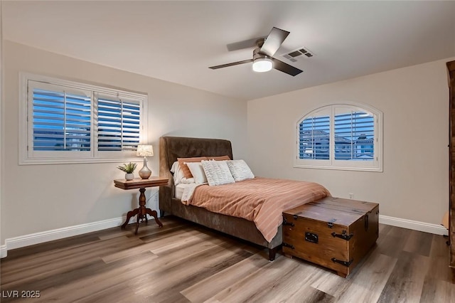 bedroom with baseboards, wood finished floors, and ceiling fan