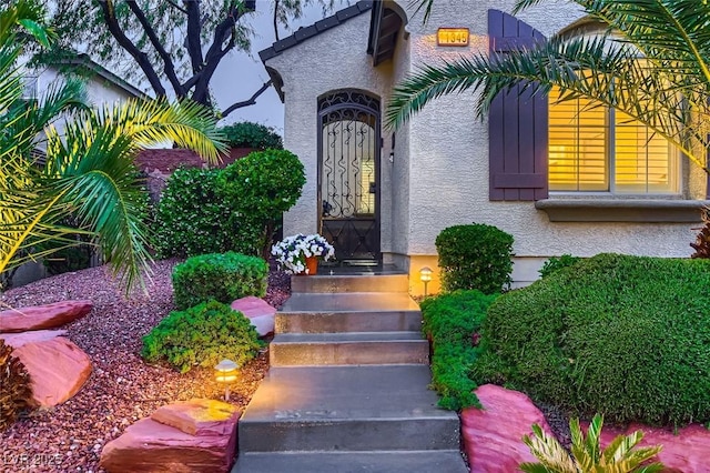 entrance to property with stucco siding