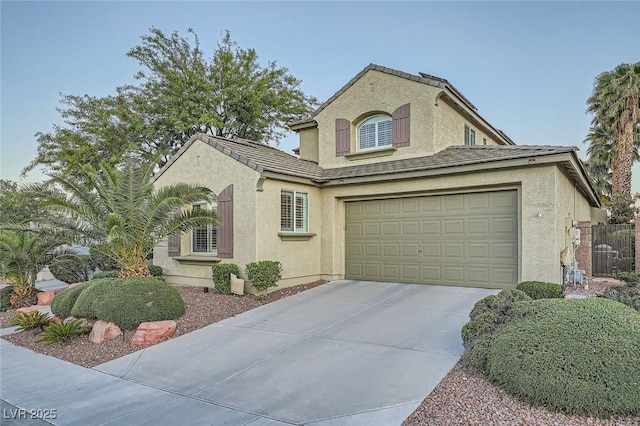 view of front of house with stucco siding, concrete driveway, and a garage