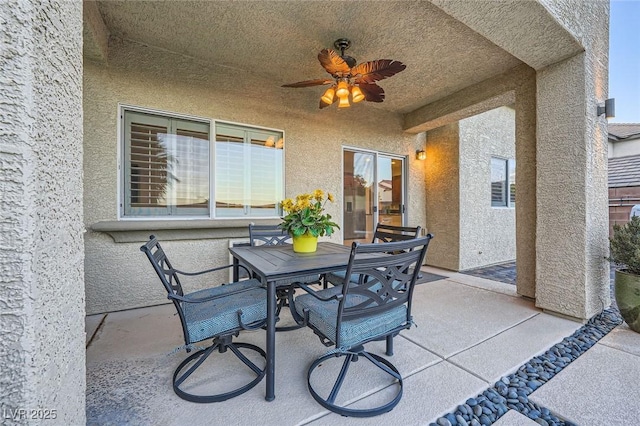 view of patio featuring outdoor dining space and a ceiling fan