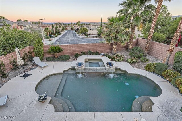 view of swimming pool featuring an in-ground hot tub, a fenced backyard, and a residential view