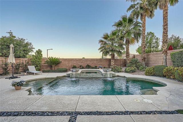 view of pool with an in-ground hot tub, a fenced backyard, and a patio
