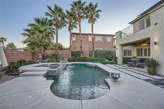 view of swimming pool with a fenced backyard, a patio, and a pool with connected hot tub