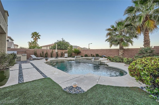 view of swimming pool with a fenced backyard, a patio, and a pool with connected hot tub