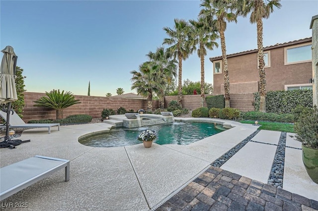 view of pool with a fenced backyard and a patio