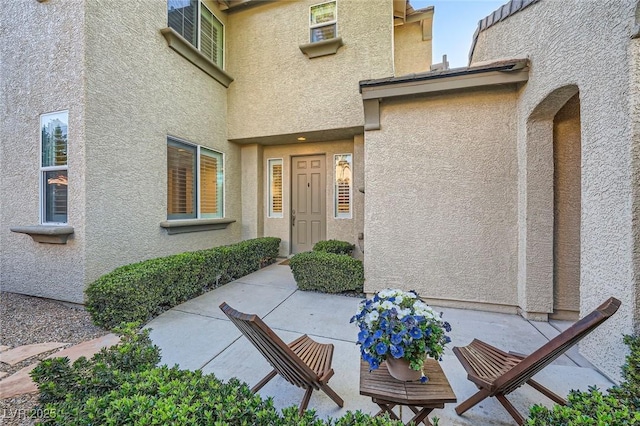 view of exterior entry with stucco siding