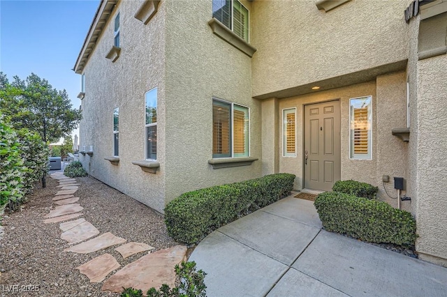entrance to property featuring stucco siding