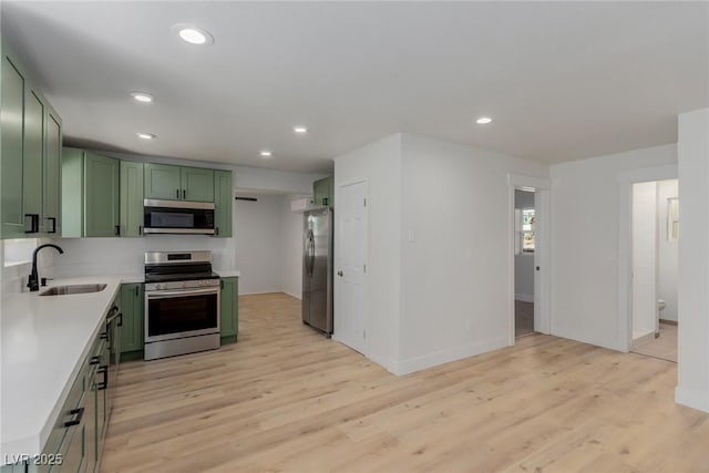 663 D Ave, Boulder City, NV 89005 - kitchen with green cabinetry, appliances with stainless steel finishes, a sink, light countertops, and recessed lighting