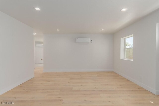 663 D Ave, Boulder City, NV 89005 - empty room featuring a wall mounted AC, recessed lighting, light wood-style floors, and baseboards