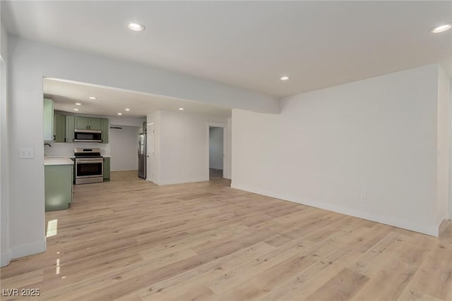 663 D Ave, Boulder City, NV 89005 - unfurnished living room featuring recessed lighting, light wood-style flooring, baseboards, and a sink