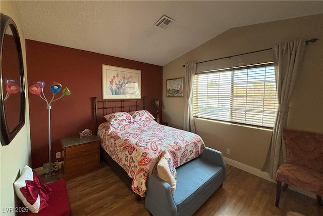 1800 Edmond St Unit 218, Las Vegas, NV 89146 - bedroom with wood finished floors, vaulted ceiling, and baseboards
