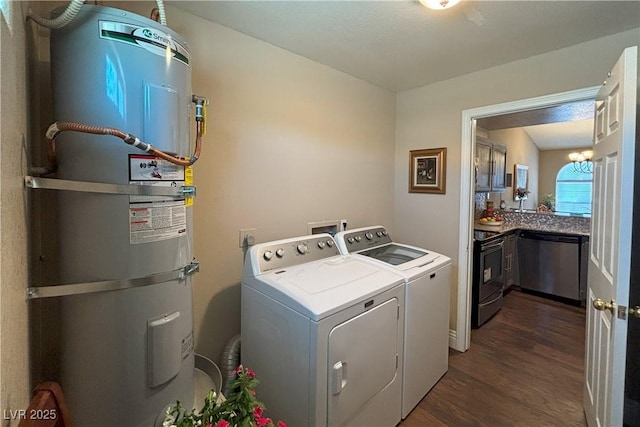 1800 Edmond St Unit 218, Las Vegas, NV 89146 - laundry room with strapped water heater, washer and clothes dryer, and dark wood-style floors