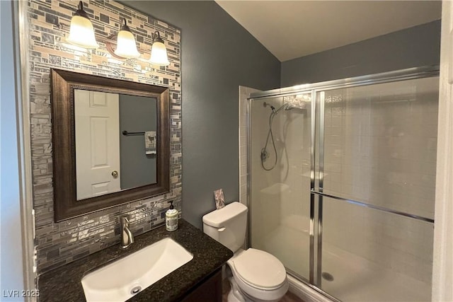 1800 Edmond St Unit 218, Las Vegas, NV 89146 - bathroom featuring backsplash, a shower stall, toilet, and vanity
