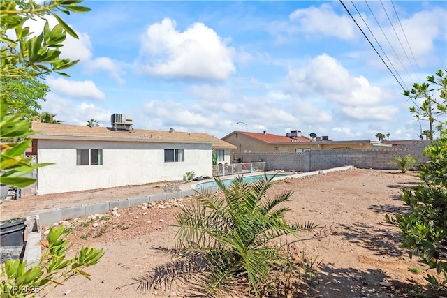 3661 Margarita Way, Las Vegas, NV 89103 - rear view of property with a fenced backyard, central AC unit, and stucco siding