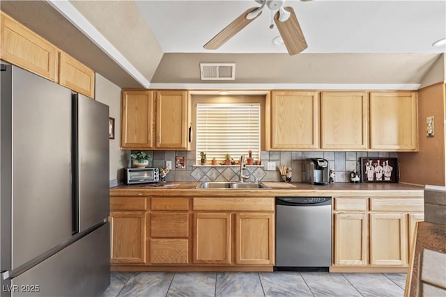 3661 Margarita Way, Las Vegas, NV 89103 - kitchen featuring stainless steel appliances, light brown cabinets, ceiling fan, backsplash, and vaulted ceiling