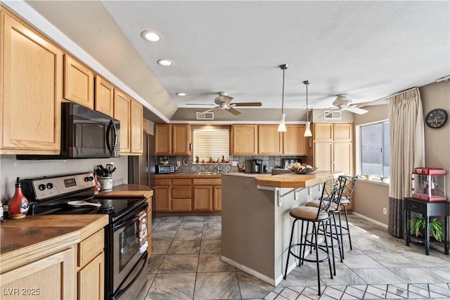 3661 Margarita Way, Las Vegas, NV 89103 - kitchen featuring stainless steel electric range, black microwave, plenty of natural light, a kitchen breakfast bar, and recessed lighting