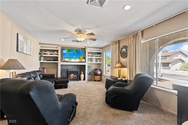 3661 Margarita Way, Las Vegas, NV 89103 - carpeted living area with a ceiling fan, a tiled fireplace, recessed lighting, built in features, and baseboards