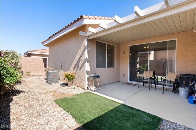 back of property featuring stucco siding, a patio, fence, and a tile roof