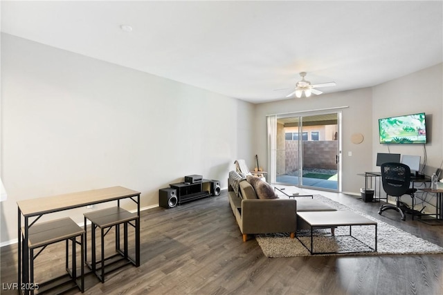 living area featuring wood finished floors, a ceiling fan, and baseboards