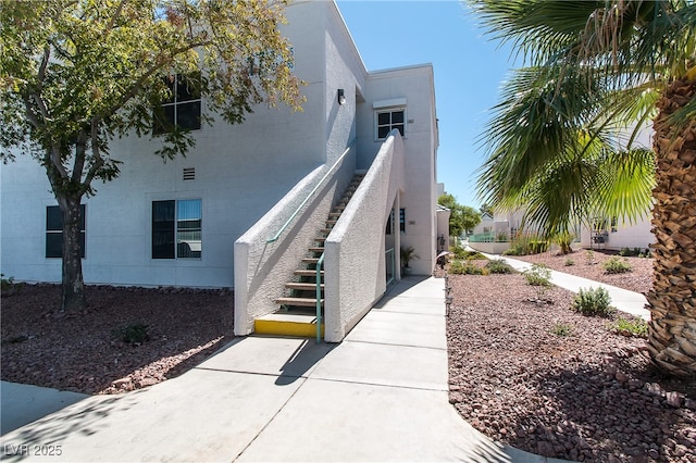 doorway to property featuring stucco siding