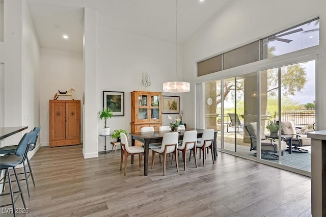 512 Pima Canyon Ct, Las Vegas, NV 89144 - dining space featuring a towering ceiling, light wood-style floors, and recessed lighting