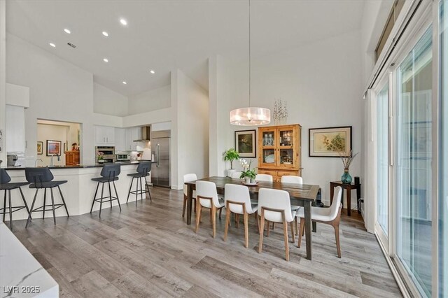 512 Pima Canyon Ct, Las Vegas, NV 89144 - dining room featuring a high ceiling, light wood-style floors, recessed lighting, and a chandelier