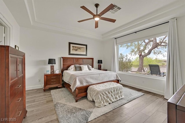 512 Pima Canyon Ct, Las Vegas, NV 89144 - bedroom with a raised ceiling, light wood-type flooring, and ceiling fan