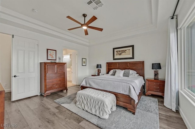 512 Pima Canyon Ct, Las Vegas, NV 89144 - bedroom featuring wood finished floors, a tray ceiling, ensuite bathroom, and a ceiling fan