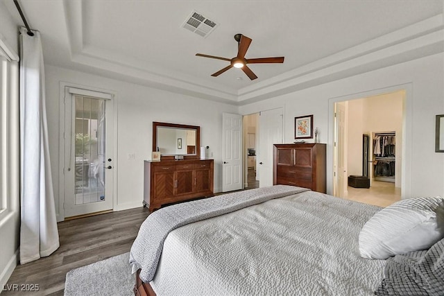 512 Pima Canyon Ct, Las Vegas, NV 89144 - bedroom featuring a raised ceiling, wood finished floors, access to exterior, and ceiling fan