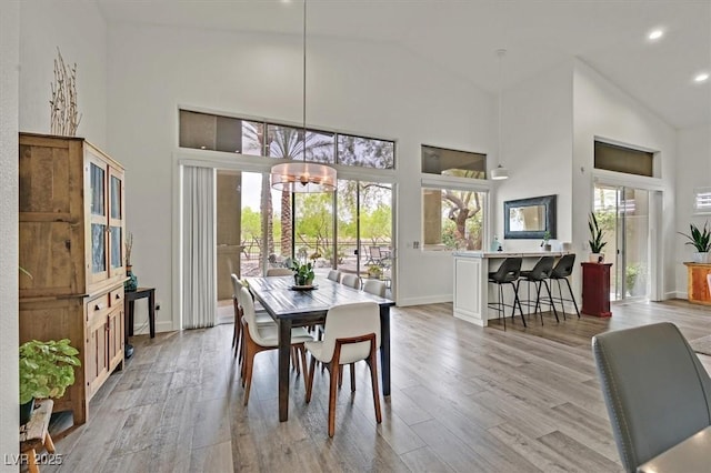 512 Pima Canyon Ct, Las Vegas, NV 89144 - dining room featuring high vaulted ceiling, light wood-style flooring, recessed lighting, and a chandelier