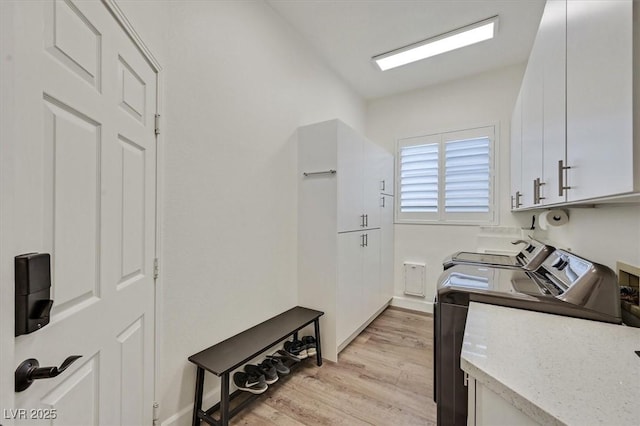 512 Pima Canyon Ct, Las Vegas, NV 89144 - laundry room featuring cabinet space, light wood-type flooring, and washing machine and clothes dryer
