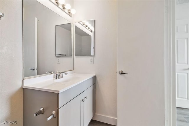 bathroom with vanity and wood finished floors