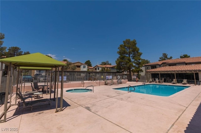 community pool featuring a gazebo, a hot tub, fence, and a patio