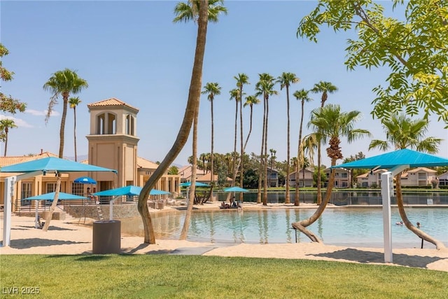 view of jungle gym featuring a water view and a yard