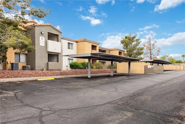 partially covered parking lot featuring fence